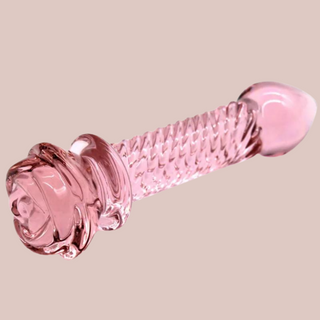 An angled view of the rose pink glass dildo, you can see the blossoming rose head.