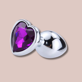 A close up view of the heart shaped purple jewelled end to the large butt plug from House Of Chastity.