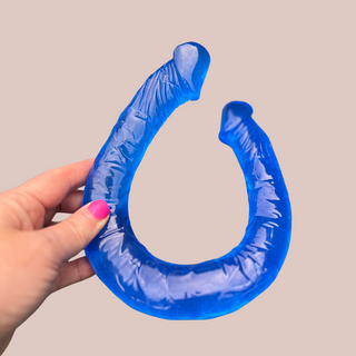 Another view of the blue double ended dildo, you can that the colour runs right through it and the hand gives an idea of size.