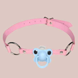 A pink pvc long gag that has a pale babu blue  dummy fixed to the front which the wearer will have to hold in their mouth and a silver buckle fastening to the back. 