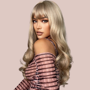 A blonde ombre long-length wig with a gorgeous soft curl running through it. Modelled for House of Chastity it has a very natural flowing look. There is a soft fringe. View from the side with locks cascading down the models back.