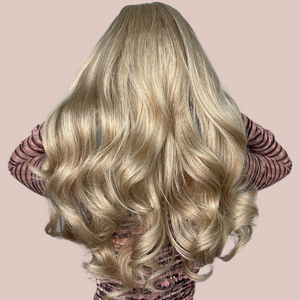 A blonde ombre long-length wig with a gorgeous soft curl running through it. Modelled for House of Chastity it has a very natural flowing look. View is from the back and shows its voluminous look.  Edit alt text