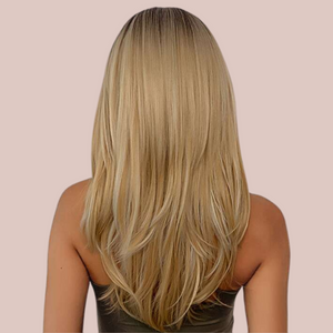 HOC259-1 Flowing Layered Locks Wig modelled for House of Chastity. A natural-looking wig with the dark roots flowing into luscious blond locks, the wig has a gentle layered effect that really makes the hairstyle pop. Rear view highlighting long layers.