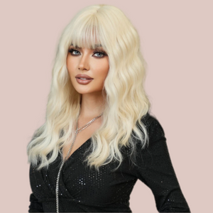 HOC9262-2 Platinum Blonde Soft Wave Long Length Hair modelled for House of Chastity. Long length platinum blonde wig, in the images the curls have been teased into soft waves and along with the long length fringe it creates a very soft look.