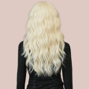 HOC9262-2 Platinum Blonde Soft Wave Long Length Hair modelled for House of Chastity. Long length platinum blonde wig, in the images the curls have been teased into soft waves and along with the long length fringe it creates a very soft look. View is from the rear showing the long full length of the wig.