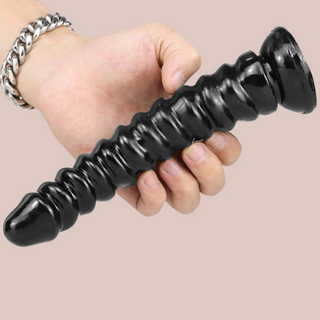 The black ribbed dildo from House Of Chastity is shown being held to give an idea of the size of the item.