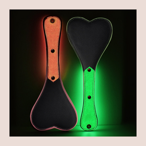An image of the Luminous Spanking Paddle from House Of Chastity, it is shown here lit up.