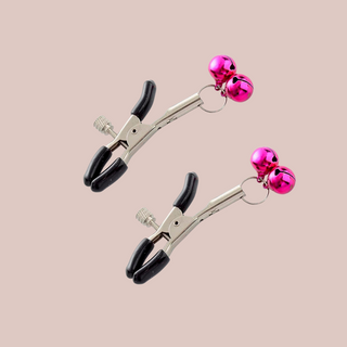 A close up of the nipple clamps which squeeze open but can be tightened by a screw, this set has pink bells attached.