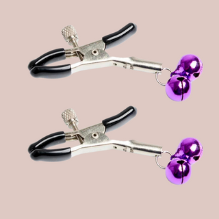 A close up of the nipple clamps which squeeze open but can be tightened by a screw, this set has purple bells attached.