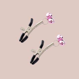 A close up of the nipple clamps which squeeze open but can be tightened by a screw, this set has pale pink bells attached.