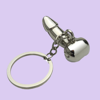 The key ring is lying on its base with the key ring attachment showing