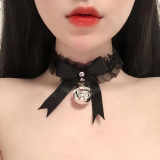 A satin and gauze fabric choker / necklace that has a matching satin bow to the front, with a large hanging bell. There are ribbon string ties to the back, allowing for different sized necks and it comes in soft black.