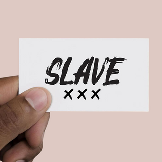 The Slave Temporary Tattoo shown on its protective paper and ready to apply. Please note that the image has been flipped to show the word the correct way around.