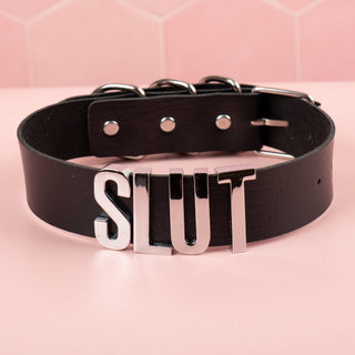 The black faux leather collar with silver SLUT lettering.