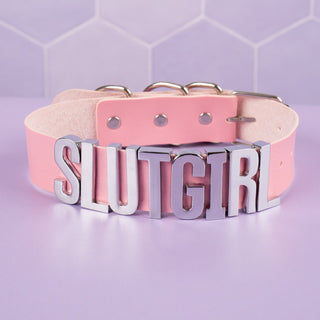 The Slut Girl Collar in pink with silver lettering.