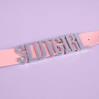 A close up of the silver lettering on the Slut Girl collar