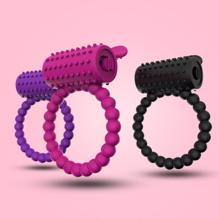 A close up of the vibrating cock ring in the three colours that it is available in, purple, pink and black.