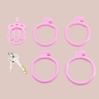 Showing The Thrall Pink Chastity Cage Kit, the cage, 4 base rings and integral lock with 2 keys.