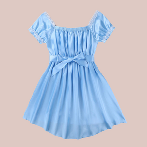 Shown here is the blue version of the satin night dress. It is an above knee length dress with a skater skirt, ruched satin bodice with decorative bow, square neckline, ruched and lace edged short sleeves and matching satin tie belt that has been tied at the front with a large bow.