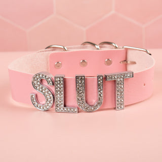 The Slut collar in pink with the silver and rhinestone lettering.