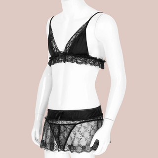 An angled view of the three piece lace bra panties and skirt displayed on a mannequin.